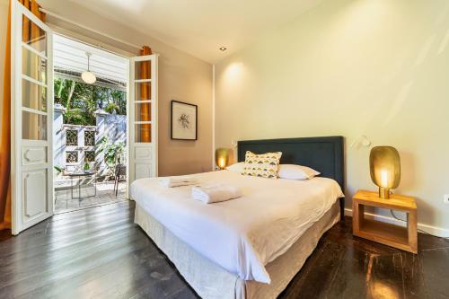 a bedroom with a bed and a large window at La Garçonniere in Saint-Pierre