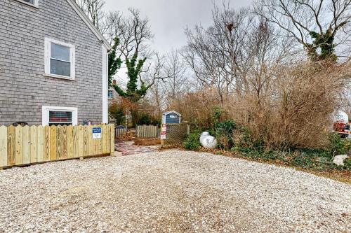 a home with a wooden fence and a driveway at The Joyce Ellen in Provincetown