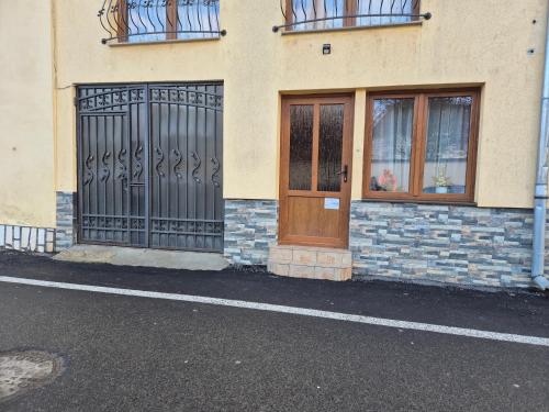 a building with a door and windows on a street at Ava Studio in Cisnădie