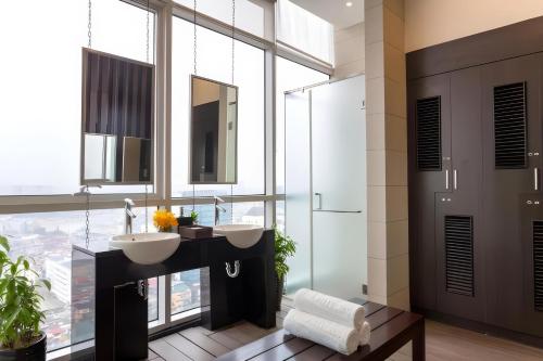 a bathroom with two sinks and a large window at SIMI Homes Lancaster 24 Cozy Studio for 4 in Luxury Building with Heated Pool, Fitness and Spa Hanoi Center in Hanoi