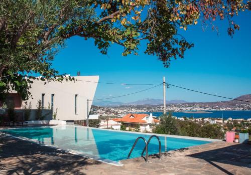 a swimming pool in a villa with a view at Hippie Bay Complex in Porto Rafti