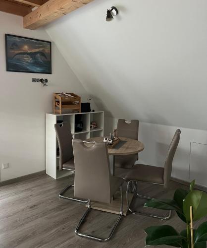 a dining room with a table and chairs at Haus Eldena in Greifswald
