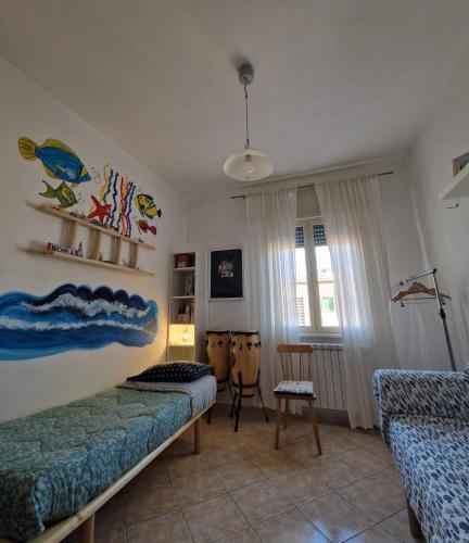 a bedroom with a bed and a couch and a window at Micky e Piero Room in Guidonia