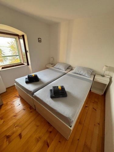a bedroom with a large bed and a window at Kameni cvijet in Murvica