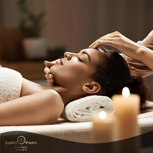 a woman laying in a bathtub getting a massage at Euro Park Otel in Istanbul