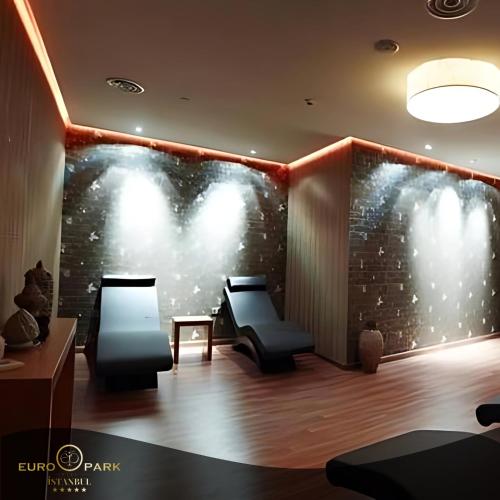 a room with two chairs and a wall with lights at Euro Park Otel in Istanbul