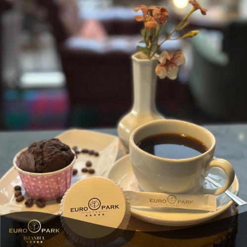 a cup of coffee and a muffin on a table at Euro Park Otel in Istanbul