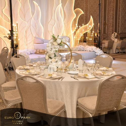 a table with a white table cloth and flowers on it at Euro Park Otel in Istanbul