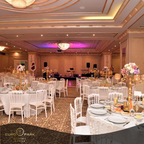 a banquet hall with white tables and white chairs at Euro Park Otel in Istanbul