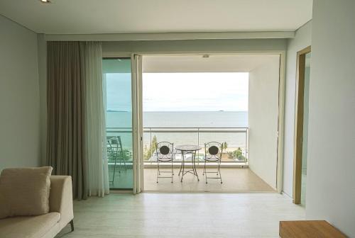 a living room with a view of the ocean at Veranda Residences Pattaya By Phung in Jomtien Beach