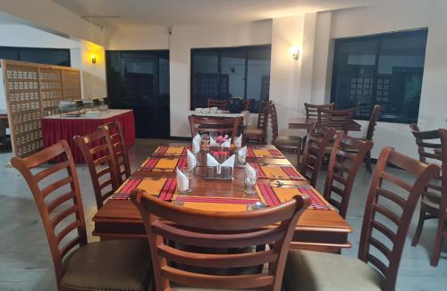 a dining room with a table and chairs at Ol Muteita Lodge in Nakuru