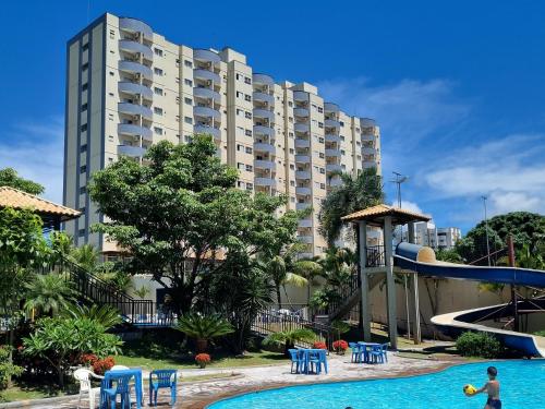 a large apartment building with a pool and a water slide at Flat 902 Golden Dolphin Express in Caldas Novas