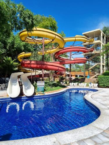a water slide at a resort with a pool at Flat 902 Golden Dolphin Express in Caldas Novas