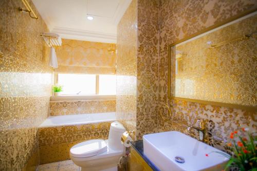 a bathroom with a toilet and a sink and a tub at Lace Boutique Hotel in Johor Bahru