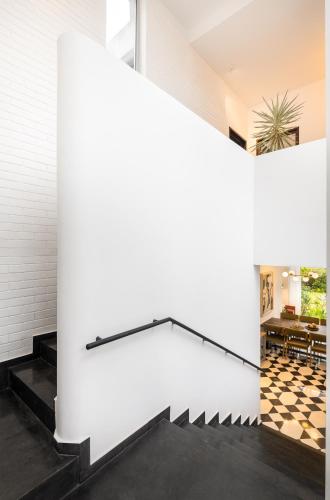 a staircase in a house with a white wall at La Zamora, 3BHK Villas near Vagator & Anjuna Beach, North Goa with Private Pool, Garden, Terrace & Security in Assagao