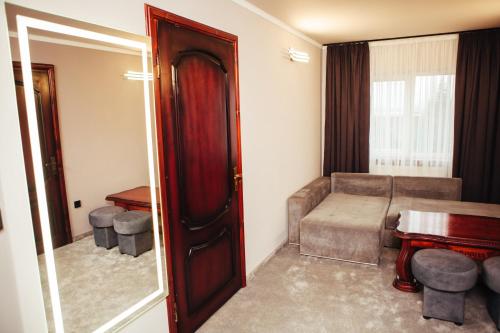 a living room with a couch and a table at Європа готель in Solomonovo