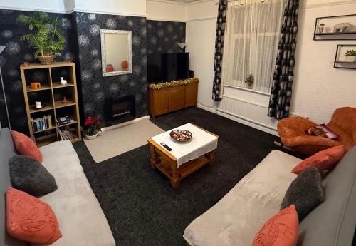 a living room with two couches and a tv at Rotherham Kimberworth in Kimberworth