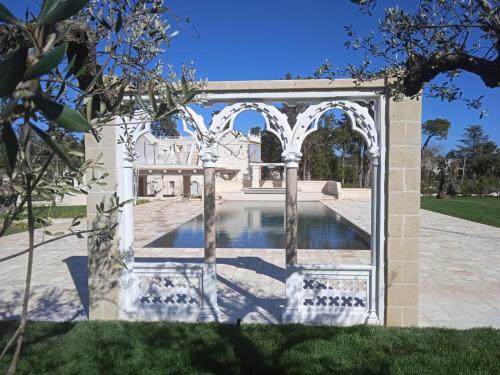 an entrance to a villa with a swimming pool at Borgo dei Lecci Puglia in Selva di Fasano