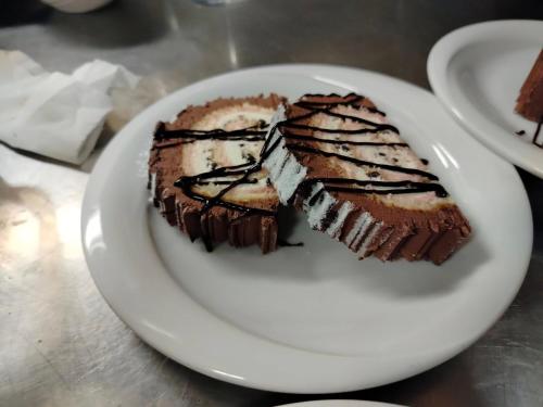 a white plate with a piece of chocolate cake at Hotel Sporting in Casarsa della Delizia