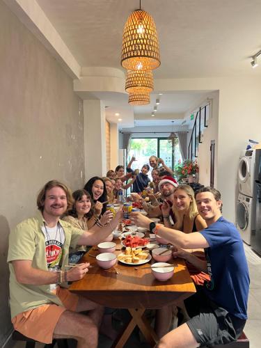 a group of people sitting around a wooden table at Okra Hoian in Hoi An