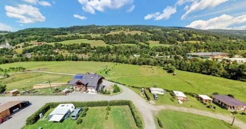 an aerial view of a farm with vehicles parked in a field at Da Bräuhauser in Stadl an der Mur