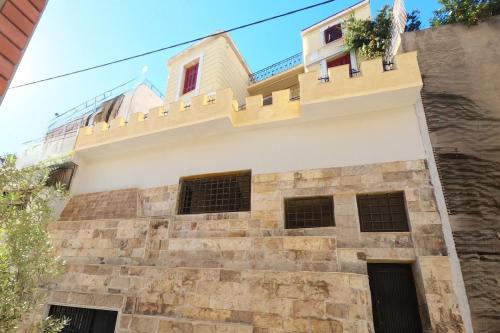 a building with a balcony on top of it at Σπίτι - Κάστρο πάνω από τη θάλασσα in Piraeus