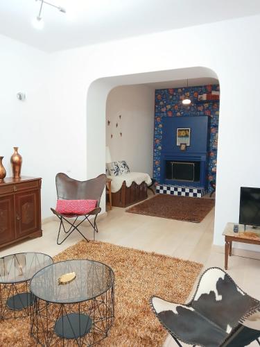 a living room with a table and chairs and a fireplace at Σπίτι - Κάστρο πάνω από τη θάλασσα in Piraeus