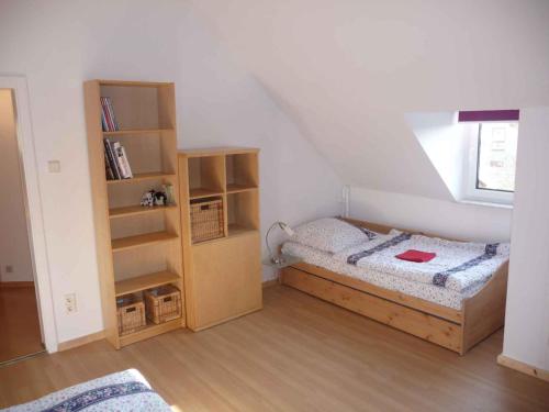 une chambre avec un lit et une étagère dans l'établissement Ferienwohnung Zur Alten Backstube, à Trebbin