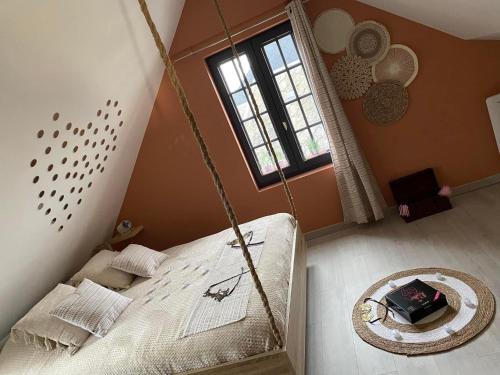 a room with a swing bed in a room at Loveroom himeros, gîte de charme avec spa in Yerville