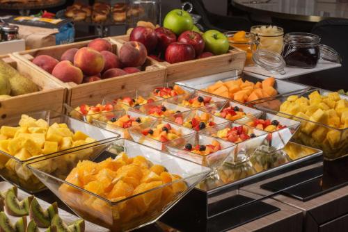 a display of fruits and vegetables in plastic bins at NH Firenze in Florence