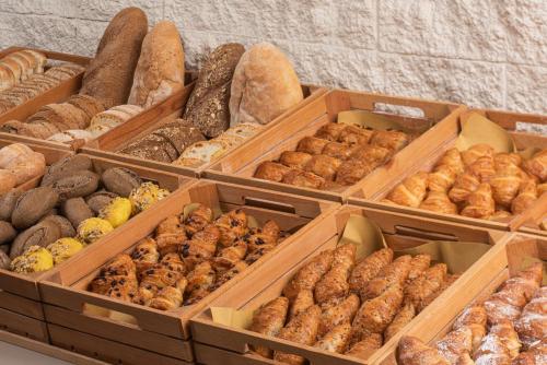 a bunch of boxes filled with different types of donuts at NH Firenze in Florence
