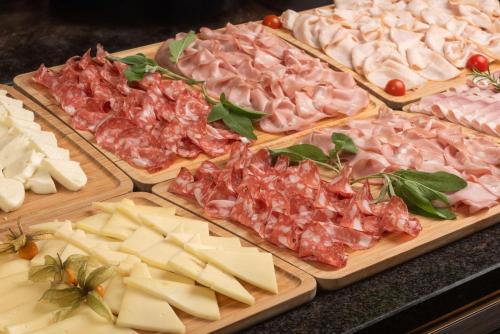 a bunch of different types of meats and cheese at NH Firenze in Florence