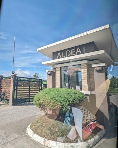 a building with a tree in front of it at A's Place - Large, 2 Bedroom Close to the Airport! in Sibulan