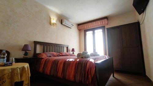 a bedroom with a bed with two teddy bears on it at Grotta Delle Fate in Ossi