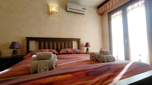 a bedroom with a large bed with two stuffed animals on it at Grotta Delle Fate in Ossi