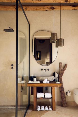a bathroom with a sink and a mirror at Nobu Hotel Marrakech in Marrakech