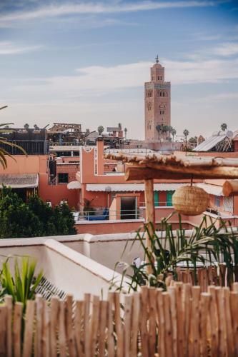 a view of a city with a clock tower at Nobu Hotel Marrakech in Marrakech