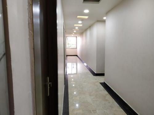 a hallway of an office building with a hallway at HOTEL SHIVGANGA COMFORT ZONE, Raipur in Raipur