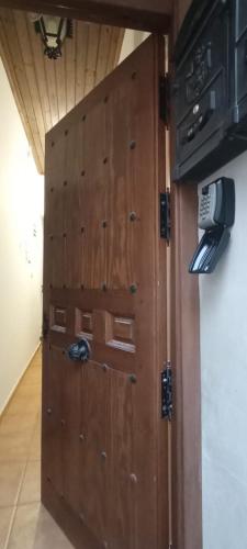 a wooden door in a room with at Las cuevas del agua in Chinchón