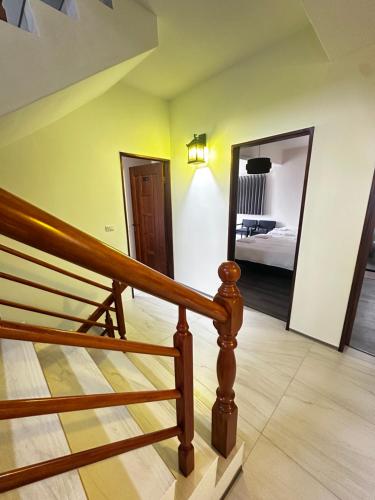 a staircase leading to a bedroom with a mirror at Guoxiang B&B in Taitung City