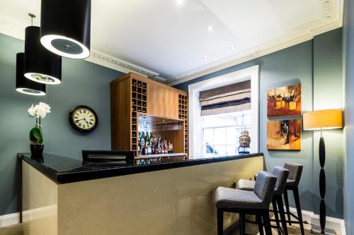 a kitchen with a clock on the wall at Montagu Place Hotel in London