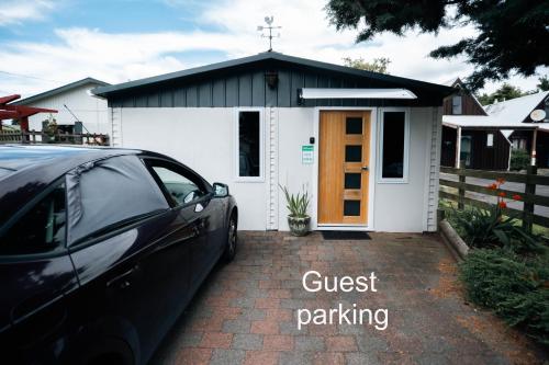 a small chapel with a car parked in front of it at Spacious sleep-out in Ohakune