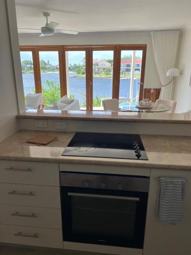 a kitchen with a counter with a large mirror at VILLA AQUILA - Mermaid Waters in Gold Coast