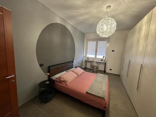 a bedroom with a bed and a large window at 4 Piano Apartment in Laveno-Mombello