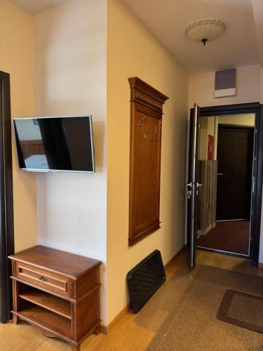 a room with a flat screen tv on a wall at Mecava Lux Kopaonik in Kopaonik