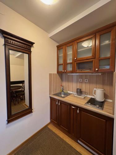 a kitchen with a sink and a mirror at Mecava Lux Kopaonik in Kopaonik