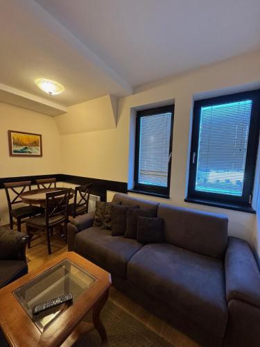 a living room with a couch and a table at Mecava Lux Kopaonik in Kopaonik