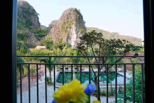 a balcony with a view of a pool and mountains at Tam Coc Green Haven Retreat in Ninh Binh