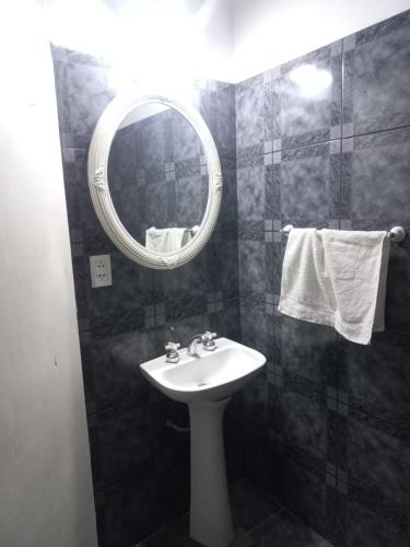 a bathroom with a sink and a mirror at Urku Wasi II in Chilecito
