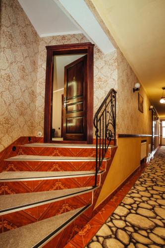 a hallway with stairs and a door in a building at Європа готель in Solomonovo